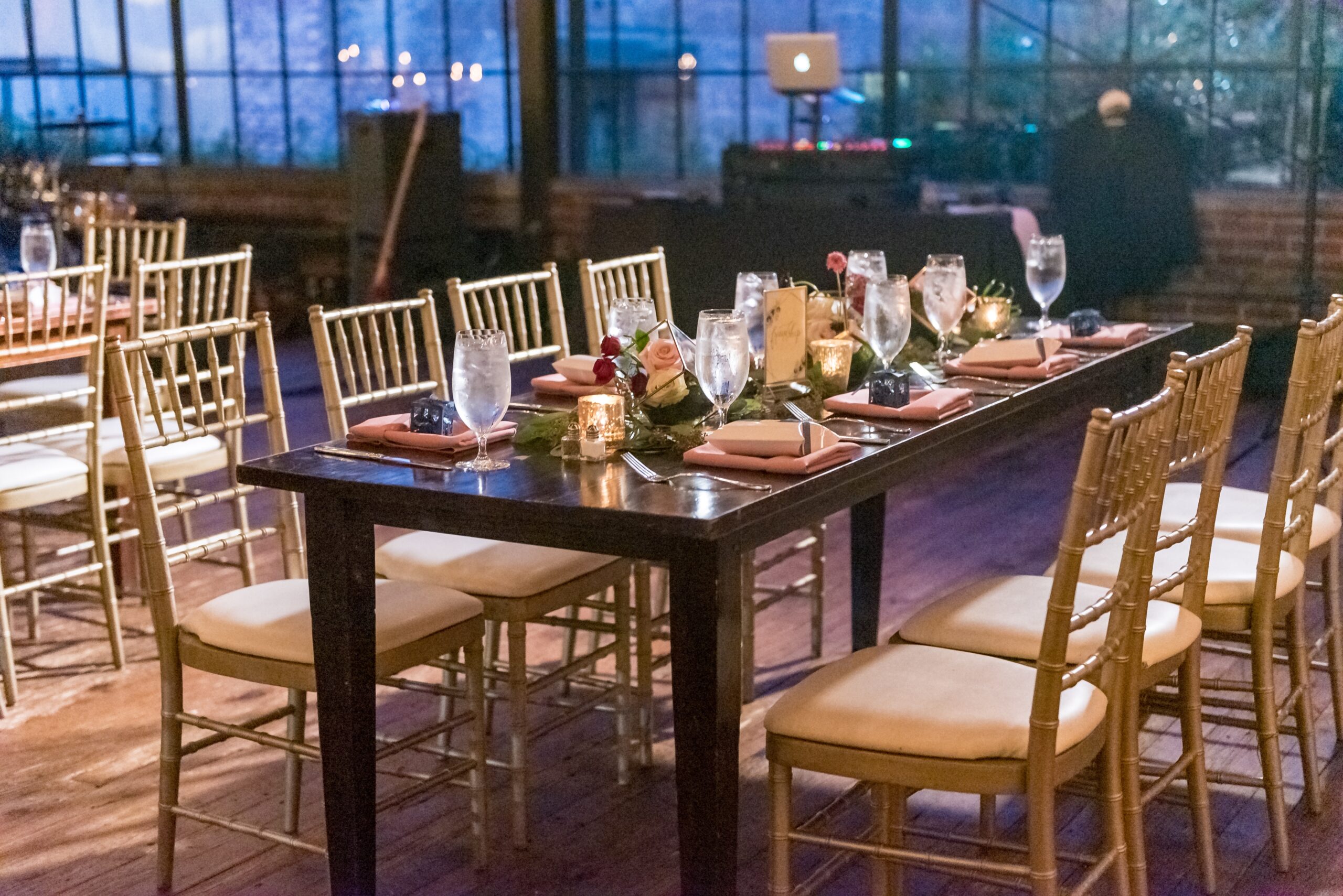A high angle shot of a table with an elegant setting in the restaurant hall in the evening